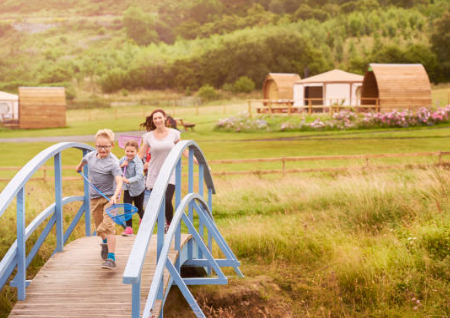 Children keeping warm by a fire pit