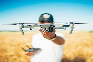 precision farming- a man holds a drone in a field